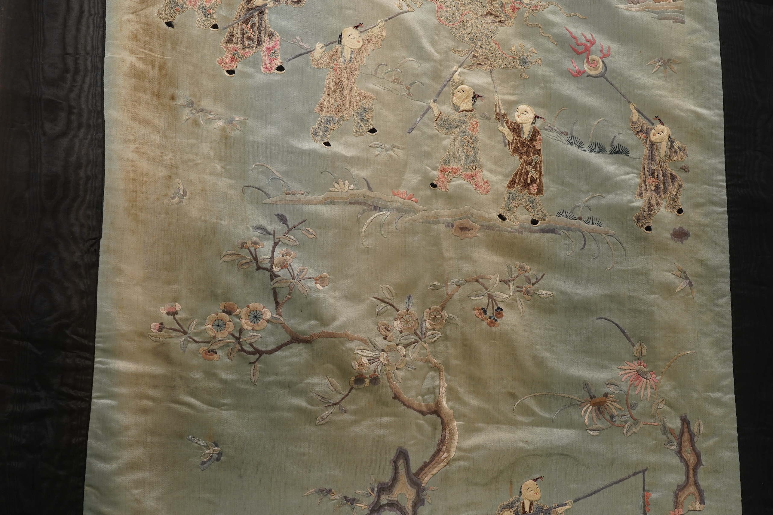 A Chinese embroidered silk ‘dragon dance’ panel, 18th/19th century